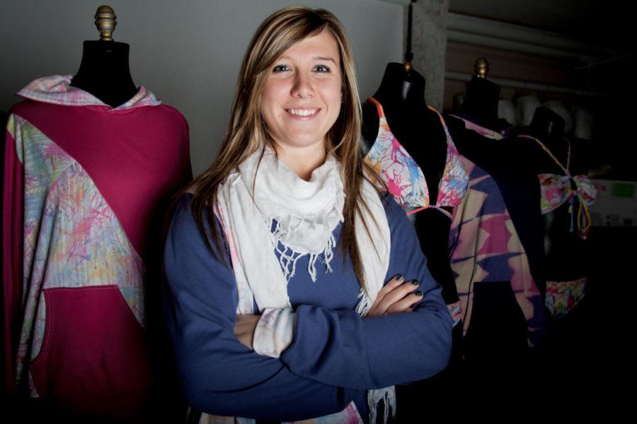 Brittney Lynch, senior in apparel merchandising, design and production, stands in front of clothing she created for her original line, Edirot. Her line Edirot, which is to ride spelled backward, is inspired by her experience with wakeboarding and water sports. Lynch interned for Quiksilver this past summer and hopes to work there again after graduating this spring.
