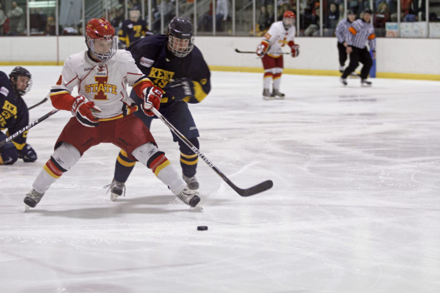 Defender Shawn Crawford fights his Kent State opponent for the
puck during the first period Friday, Jan. 13, at the Ames/ISU Ice
Arena. The Cyclones got a 6-1 victory against the Golden
Flashes. 
