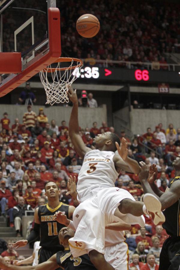 Forward Melvin Ejim reaches over Missouri defense for a layup
during the second half of Wednedays game at Hilton. Ejim had two
points and five rebounds to contribute to the Cyclones 27 team
rebounds.
