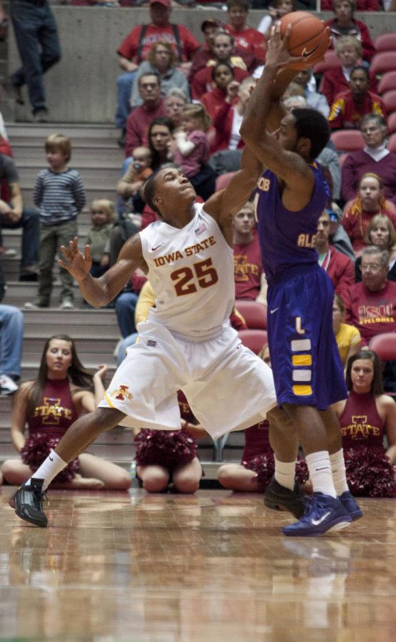 Cyclone guard Tyrus McGee attempts to block his opponents shot
during the game against Lipscomb on Wednesday, Dec. 21, at Hilton
Coliseum. 
