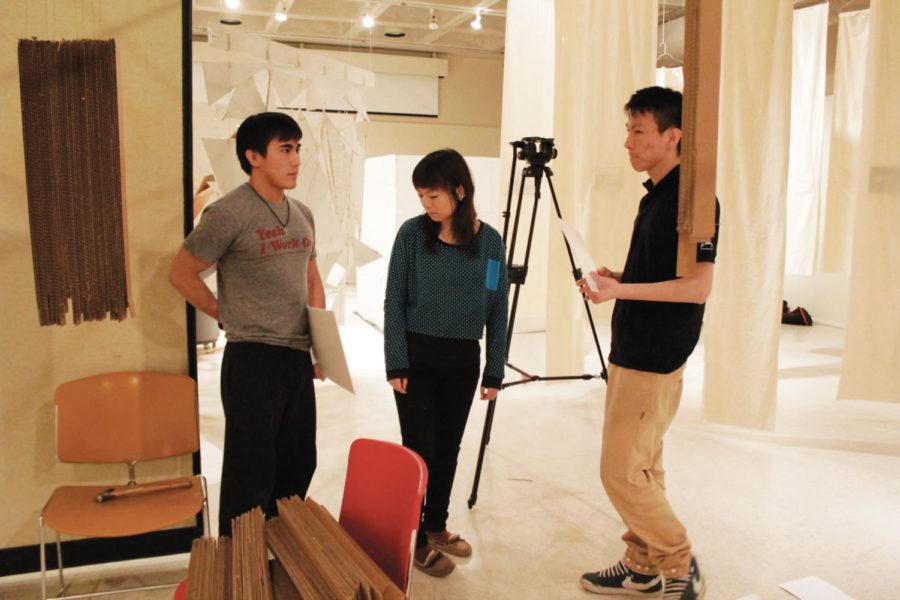 Hieu Nguyen, senior in graphic design; Xin Zheng, senior in
interior design; and Leon Lian, senior in interior design, discuss
where to display photos while installing the exhibit Graduation
in Gallery 181 of the College of Design on Monday, Jan. 16. The
exhibit will run for two weeks following an opening reception at 7
p.m. on Tuesday, Jan. 17, in the gallery. 
