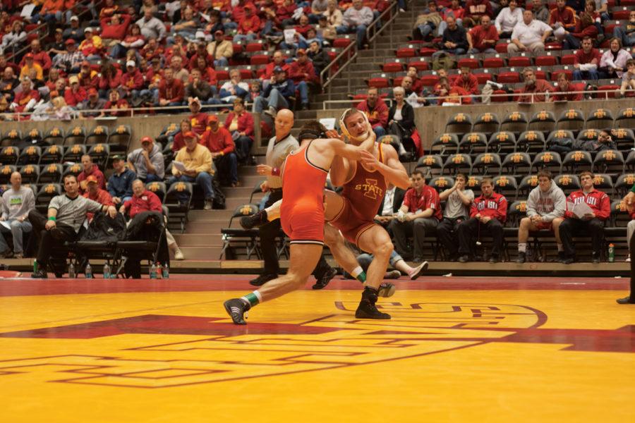 Chris Spangler tries to hold on to his late lead against Dallas Bailey of Oklahoma State. Spangler was defeated by Bailey 5-4.The Big 12 Tournament was held Saturday, March 5 at Hilton Coliseum.