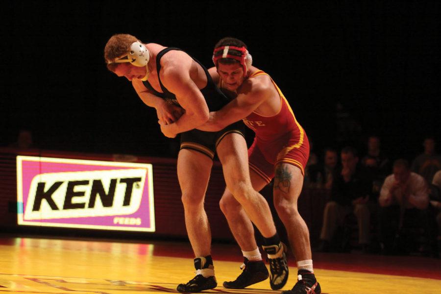 Freshman Mikey England grapples with Missouri senior Patrick
Wright during their 174-pound match in the Cyclones dual meet on
Sunday, Jan. 9, at Hilton Coliseum. Englands match went into
overtime, with Wright winning 4-2.
