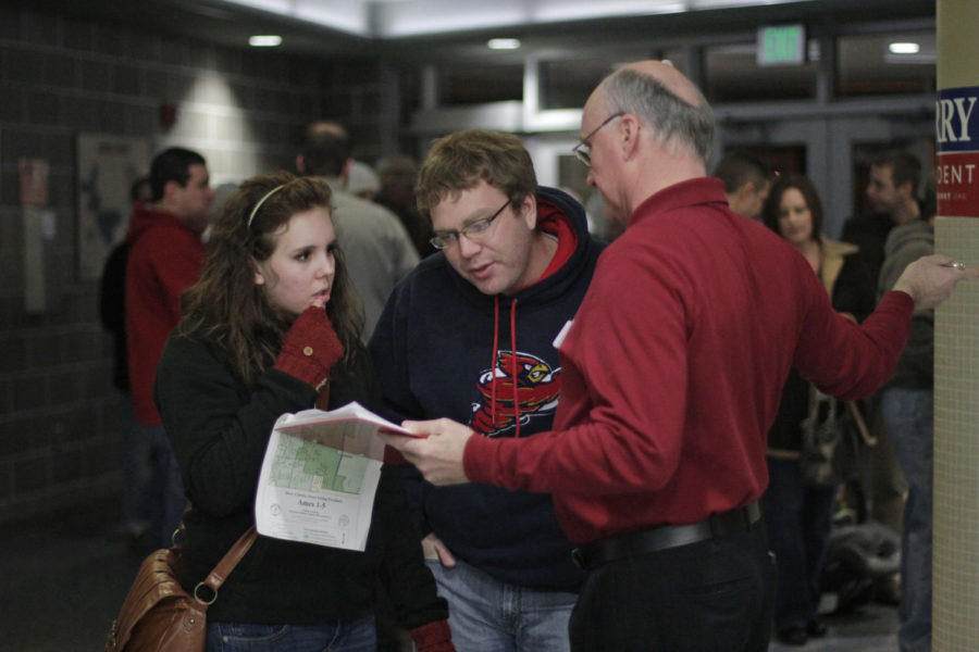 Jenna Miller and Stephen Kuster, both of Ames, consult a map of
Ames voting precincts in order to determine which caucus to attend
at Ames Middle School on Tuesday, Jan. 3. Miller and Kuster are
former ISU students who represented a small contingency of young
voters at the middle schools various caucuses.
