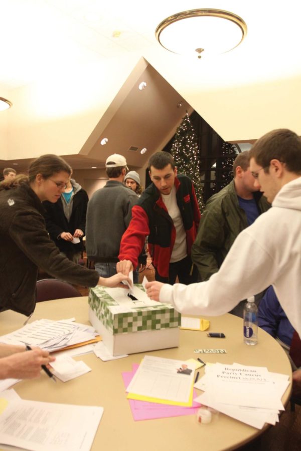Caucus-goers drop their votes in the box during the Republican
caucus at St. Johns by the Campus on Tuesday, Jan. 3.
