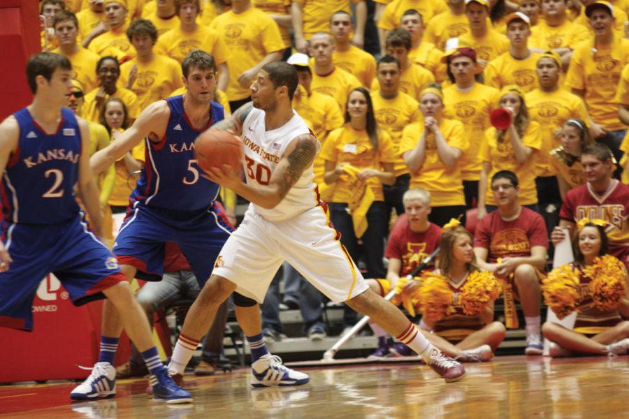 Royce White passes to a teammate around a Kansas guard in the
first half of the game Saturday, Jan. 28. The Cyclone mens
basketball team upset No. 5 Kansas 72-64.
