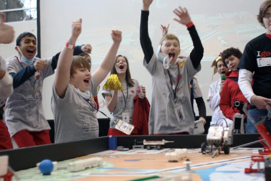 Members of the Riverdale Rocks Robots LEGO League team from Riverdale Heights Elementary School in Bettendorf celebrate as their robot successfully completes a task in the Iowa First LEGO League Championship Competition on Saturday, Jan. 15 in Howe Hall at Iowa State University. 