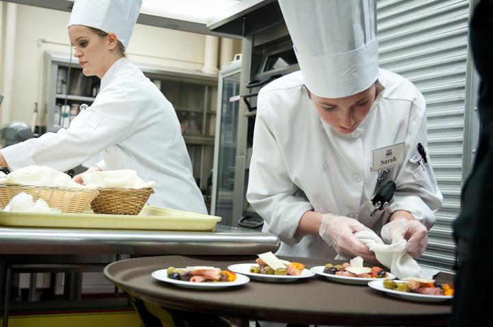 Sarah Brekke, senior in culinary science and student manager, touches up an appetizer before sending it out on Wednesday at the Joan Bice Underwood Tea Room in MacKay Hall. The Tuscan-style meal was put on by students in the fine dining management class.