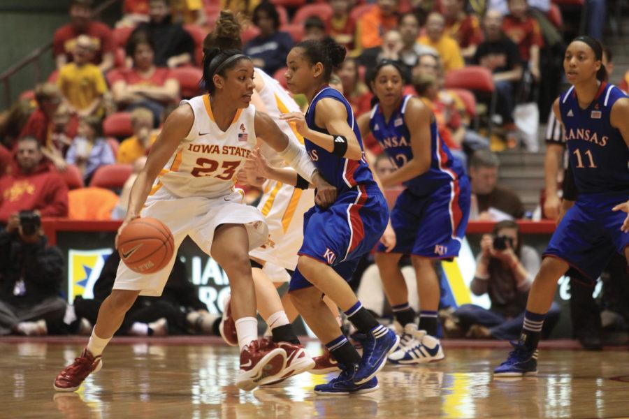 Chassidy Cole moves the ball down court against a Kansas defender on Wednesday, Feb. 15, at Hilton Coliseum. Cole leads the team with 11 assists, sharing point guard duties with Lauren Mansfield and Nikki Moody. 
