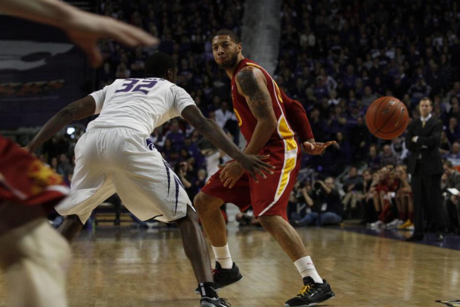 ISU forward Royce White passes the ball behind his back to guard Scott Christopherson in the first half of the Cyclones 65-61 win over Kansas State on Saturday, Feb. 25. White led the Cyclones with seven assists in the game. It was Whites fifth game with five or more assits this year.
