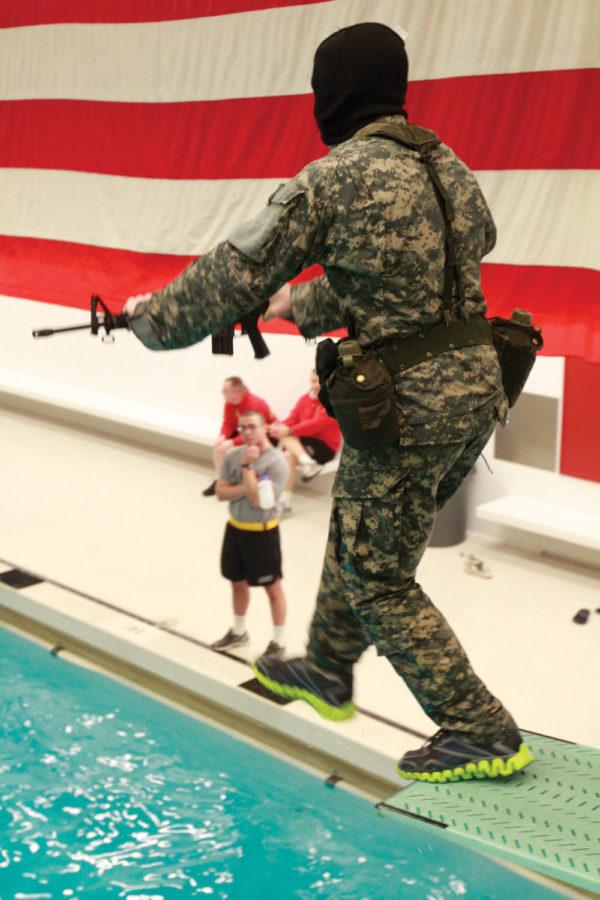 Patrick Buhl, sophomore in pre-business, jumps into the water
for 3-meter entry practice during the ROTC lab on Wednesday, Feb.
22, at Beyer Hall. 
