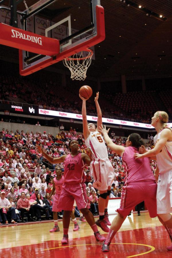 Forward Hallie Chistofferson reaches above Oklahoma defenders
for a basket during the Cyclones matchup with the Sooners on
Saturday, Feb. 18, at Hilton Coliseum. Christofferson contributed
13 points and five rebounds to the Cyclone victory.
