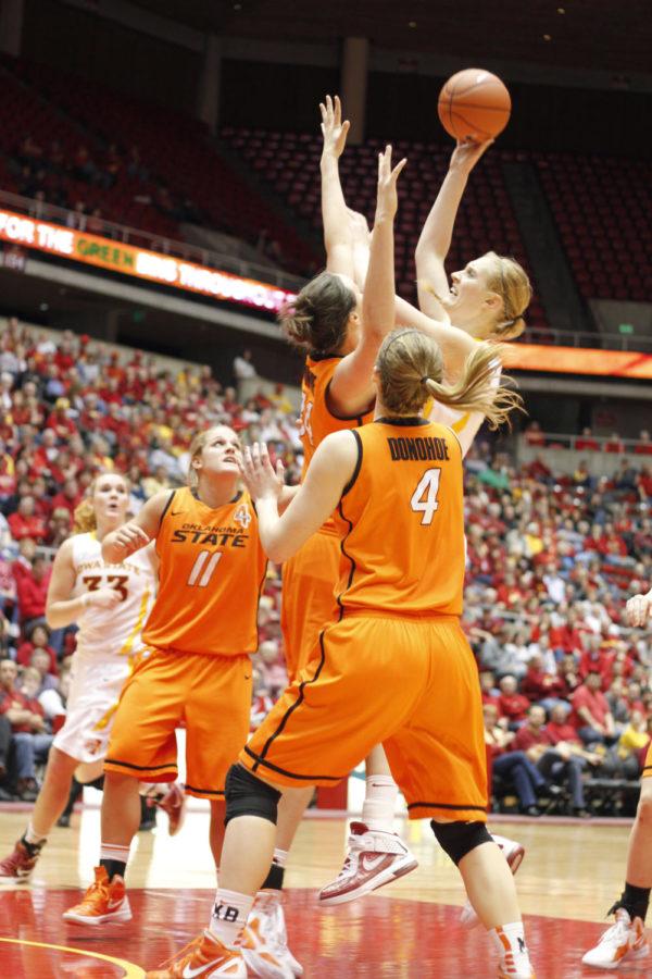 Center Anna Prins jumps over her Oklahoma State opponents for a
jump shot during Wednesday nights game at Hilton. Prins scored 16
points and went 6-9 at the free throw line to help the Cyclones
gain a 73-52 victory over the Cowgirls.

