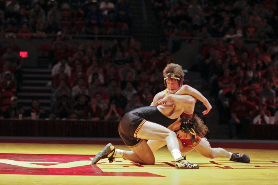 Redshirt senior Andrew Sorenson attempts to flip over Iowa
opponent Michael Evans during the Cy-Hawk meet held Sunday at
Hilton Coliseum. Sorenson defeated Evans 43, but the Cyclones fell
to the Hawkeyes 9-27.
