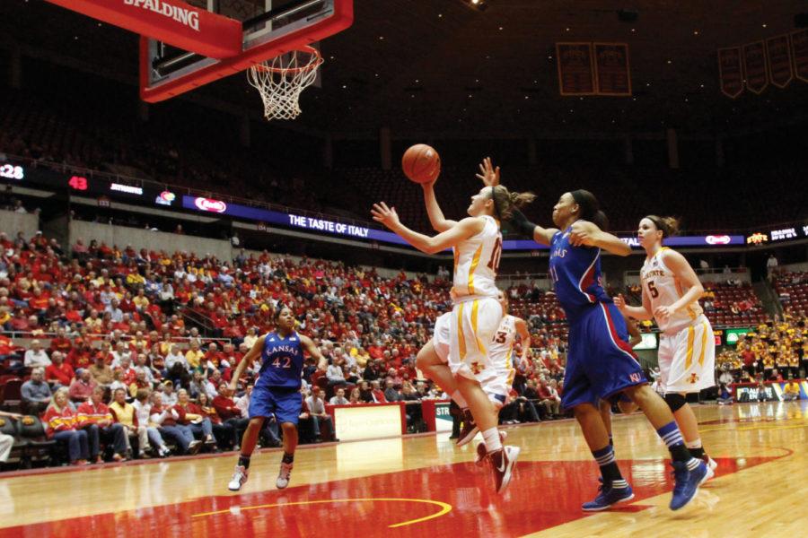 Lauren Mansfield edges out Kansas Aishah Sutherland (11) for
the basket in the second half of the Iowa State womens contest
with the Jayhawks on Wednesday, Feb. 15. Mansfield contributed on
both ends of the court, leading the Cyclones in defensive rebounds
as well as adding nine points.
