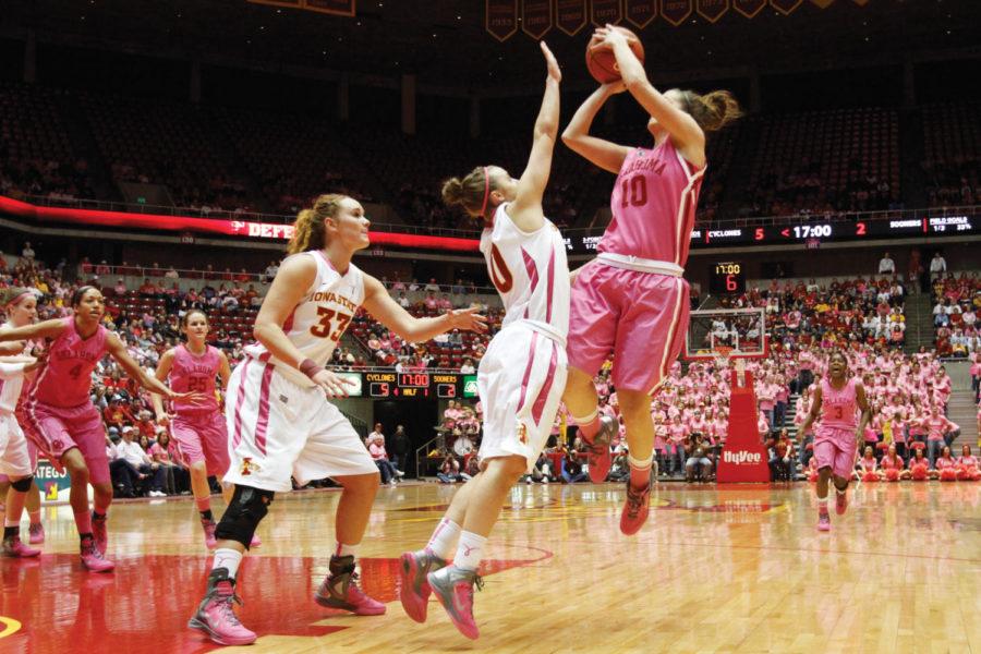 Guard Lauren Mansfield and center Chelsea Poppens defend the
shot from Oklahomas Morgan Hook on Saturday, Feb. 18, at Hilton
Coliseum. Despite Cooks 13 points for the Sooners, the Cyclones
prevailed 77-71.
