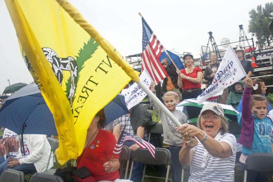 Joan Lucas, of Indianola, waves a Gadsden flag during the Tea
Party of Americas Restoring America event on Saturday, Sept. 3,
2011 in Indianola. Lucas said she came to the event to see
Sarah. 
