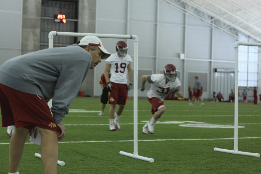 Assistant coach Courtney Messingham trains players during the
football practice Tuesday at the Bergstrom Indoor Practice
Facility.

