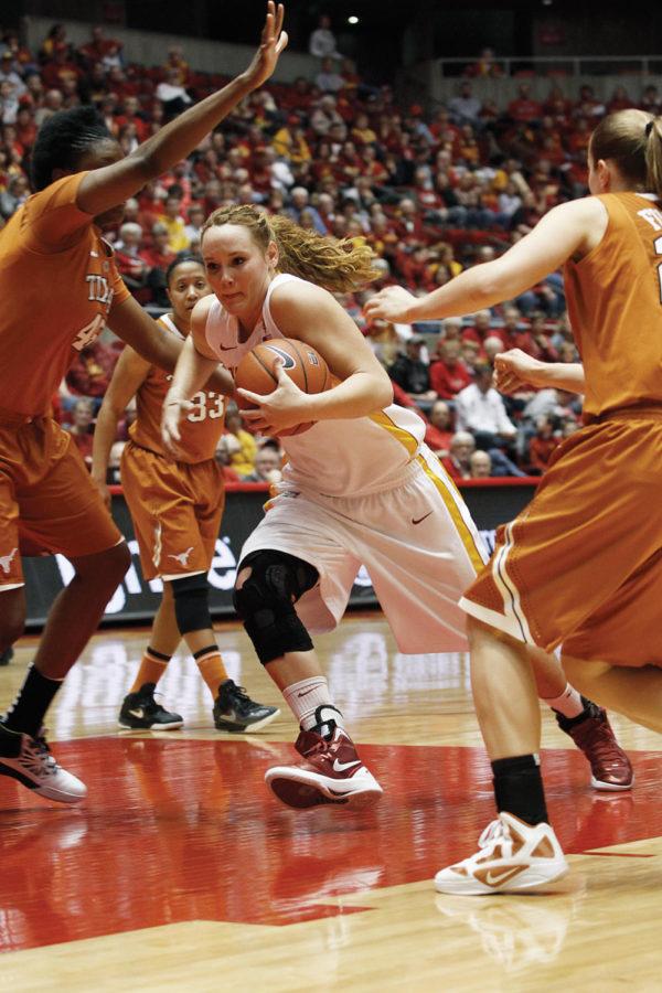 Forward Chelsea Poppens drives through the Texas opposition on
Saturday, Feb. 4. Poppens lead the team in both scoring and
rebounds, with a total of 27 points and 10 rebounds.
