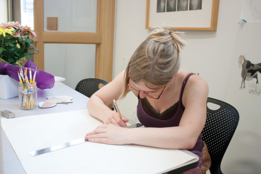 Ellen Cram, sophomore in pre-architecture, works on a drawing Friday, March 23, at the Christian Petersen Art Museum in Morrill Hall.
