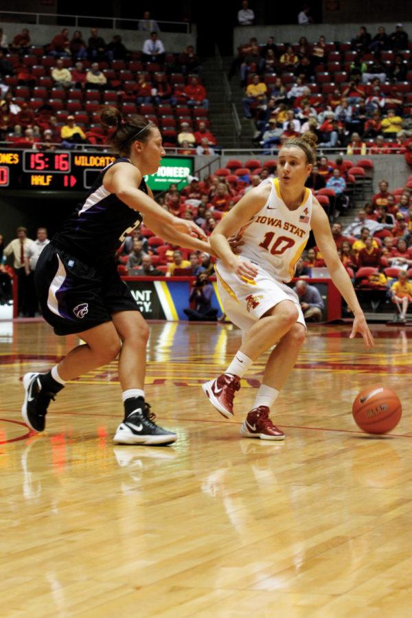 Senior guard Lauren Mansfield dribbles around a Kansas State defender during the ISU womens basketball teams game against the Wildcats on Wednesday, Feb. 29, at Hilton Coliseum. Mansfield added 13 points to the Cyclones 57-33 victory on senior night.
