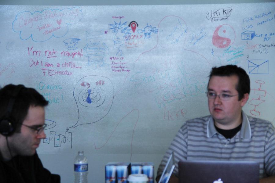 Beau Lyddon and Nick Joyce of Team Sayer Martin work on their app with team doodles on a white board in the background on Saturday, March 3. Startup Weekend brought teams together to create computer apps from scratch within 52 hours.

