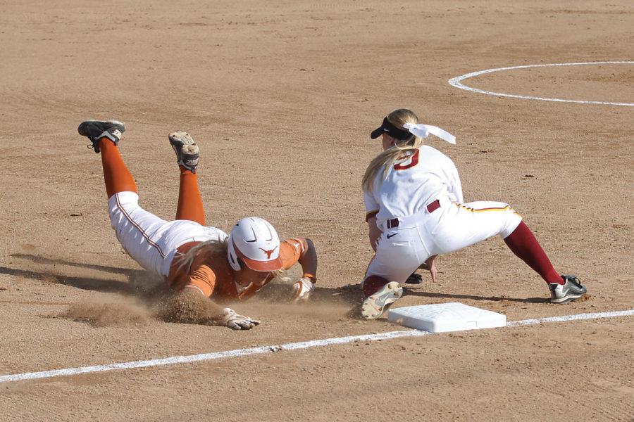 Lexi Slater, freshman third baseman, tags out a diving Texas player during the third inning of Fridays game at the Southwest Athletic Complex. This is Iowa States first of three games against Texas this weekend.

