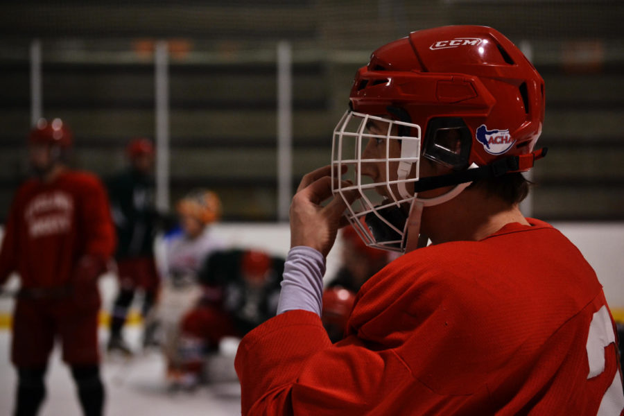Mike Scebold, senior captain and defenseman on the ISU Division III hockey team, listens intently to coach Brendan Sheehan during a drill. This is Scebolds fourth season playing for Iowa State. 
