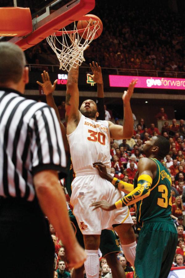Sophomore forward Royce White reaches above Baylor defenders for a basket during the mens basketball game against Baylor on Saturday at Hilton Coliseum. Whites 11 rebounds led the Cyclones in their upset over the ninth-ranked Bears in the last home game of the season. 
