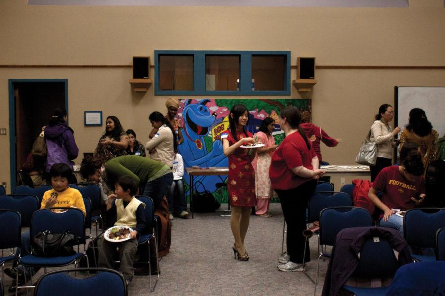 People gather at the Ames Public Library for the International Womens Day on Saturday, March 3. The event gathered women from places as far away as Africa, India and China to discuss issues affecting women and girls and to share aspects of their cultures.
