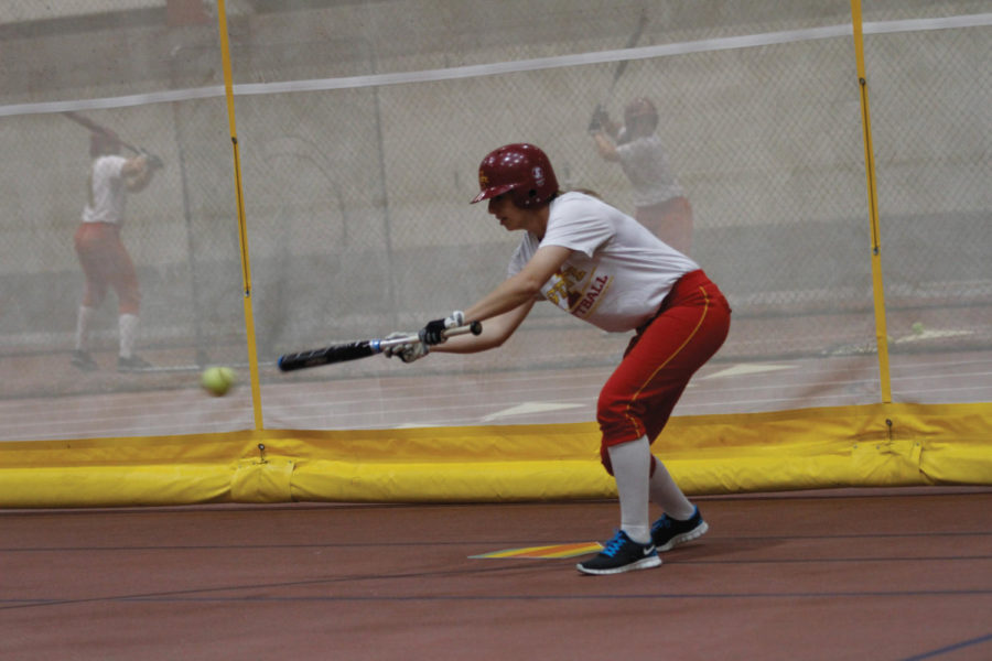 Erica Miller, junior infielder, works at the bunt station on Tuesday, Feb. 28, at Lied Recreation.
