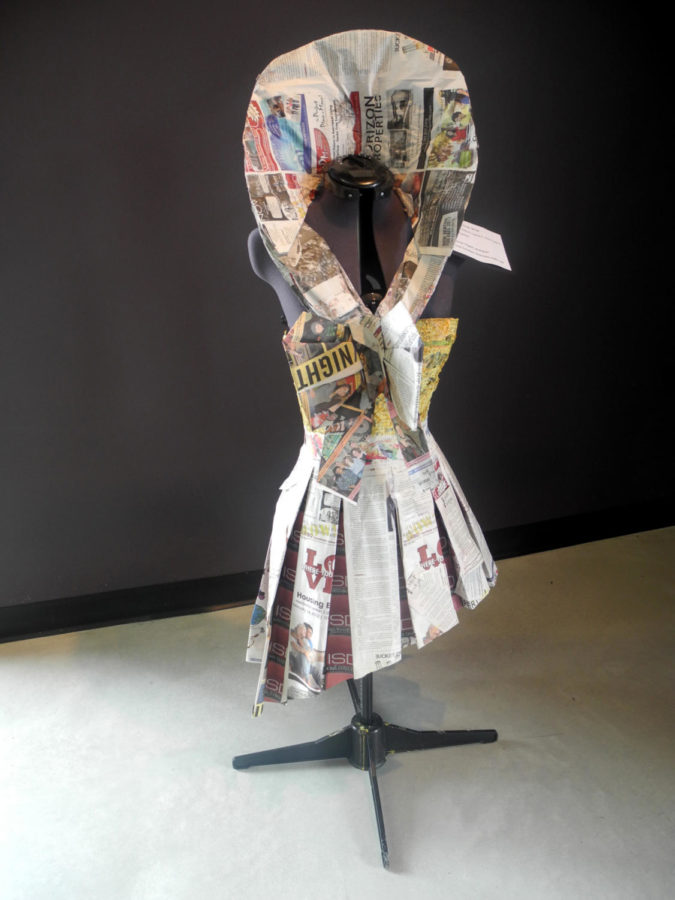 Garment constructed by Erika Smith, Lauren Lee, Anna Mackin and Laura Talken. Their inspiration was origami and pleating art. Materials used in addition to newspaper were flour/water, staples and tape.
