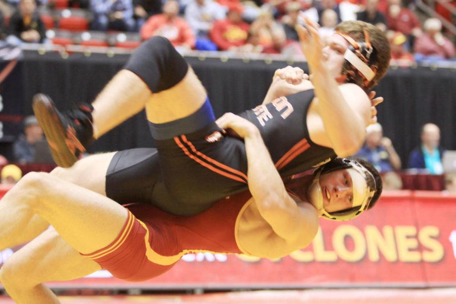 Andrew Sorenson takes down OSUs Joe Latham during the National Dual meet Sunday at Hilton. Sorenson defeated Latham 8-3 and the Cyclones lost to the Beavers 12-27, losing the semi-finals.
