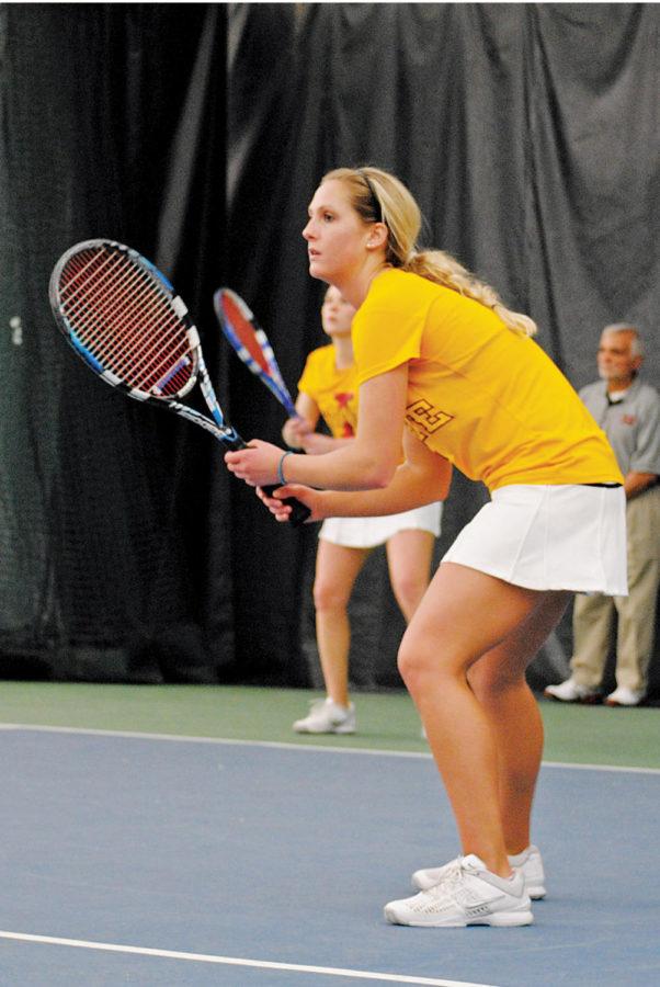 Liza Wicher prepares for a return play alongside her partner Jenna Langhorst during the Iowa State - Oklahoma State match held March 15 at the Ames Racquet and Fitness Center. 