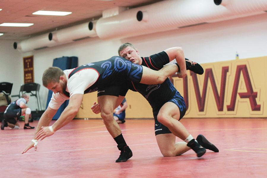 Jon Reader tries to ride Trent Paulson in training for the Olympic Team Trials on April 21-22 in Iowa City. Both were national champions their senior seasons as well as three-time All-Americans.
