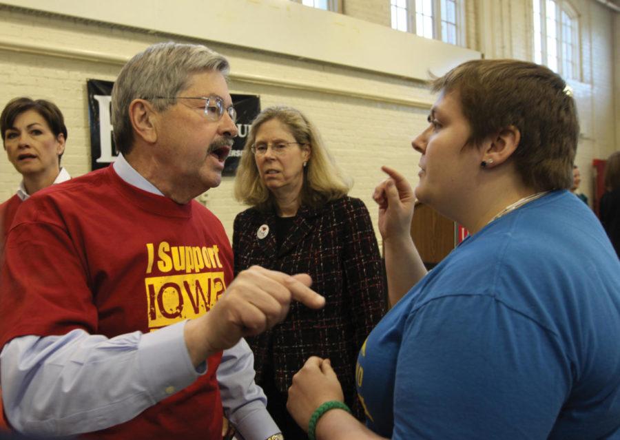 Iowa Gov. Terry Branstad discusses with Alexandria Davenport, graduate assistant in sociology, after the discussion titled "The Truth: Lean Finely Textured Beef," hosted by the ISU Block and Bridle Club on Tuesday, April 10, at the Farm Bureau Pavilion. 
