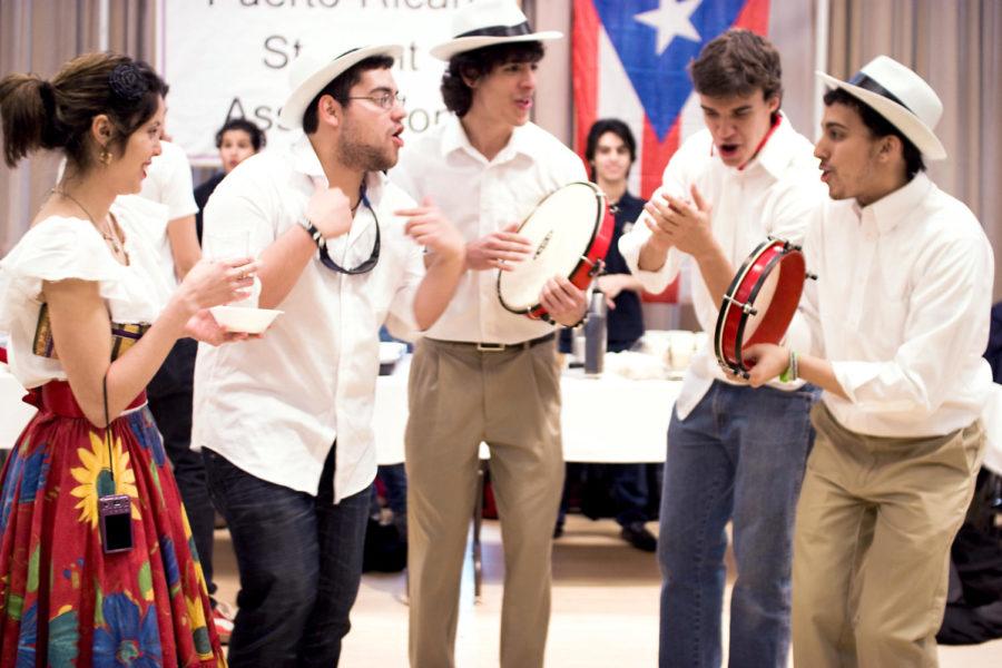 Fernando Berrios, sophomore in performing arts, Jan Michael Lopez, freshman in aerospace engineering, Samir AAgha Juarbe, freshman in veterinary science, and Sabdiel Reyes, sophomore in chemical engineering and french play Panderos for a crowd at the International Food Fair. Panderos are a drum very similar to tambourines and are often played at events and parties.
