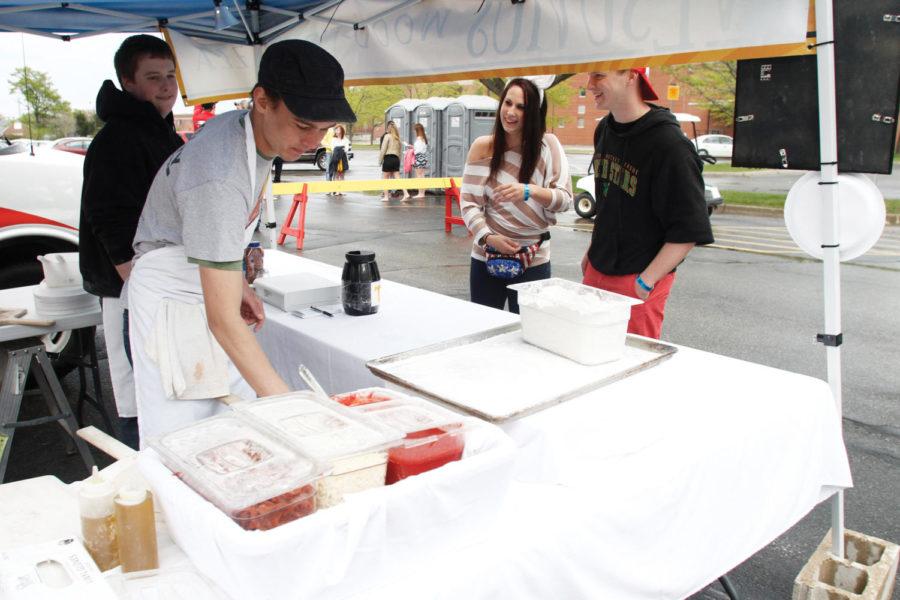 Gina Gore, senior in community and regional planning, and Jordan Calpus, senior in mechanical engineering, order pizza from Vesuvius at Taste of Veishea in the Molecular Biology parking lot on Saturday, April 21. While the rain did not deter concert-goers, the crowd at Taste of Veishea was considerably smaller. 
