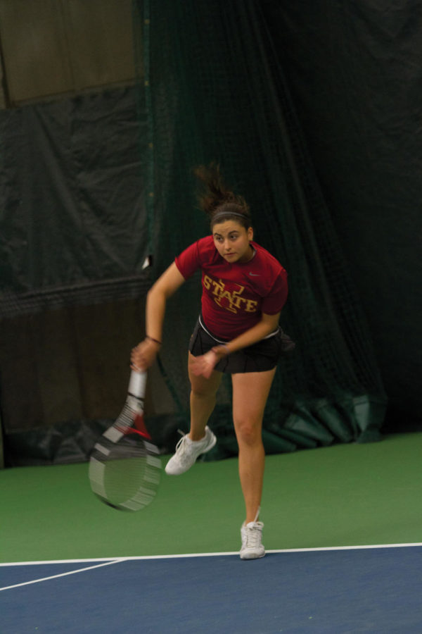 Senior Maria Macedo returns the ball during doubles play against Kansas State on Friday, April 13. Macedo was paired with Tessa Lang and the two fell to Kansas State with a final of 8-3. The event took place indoors at the Ames Racquet and Fitness due to weather conditions. 
