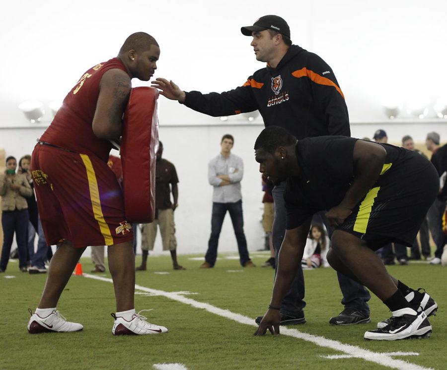 Former ISU offensive tackle Kelechi Osemele, left, and right guard Hayworth Hicks run drills for NFL recruits during the Cyclone Football Pro Day on Tuesday, March 20, at the Bergstrom Indoor Practice Facility.
