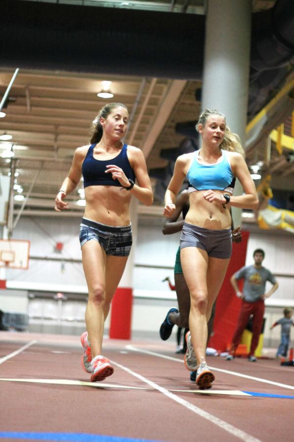 Junior Meaghan Nelson and senior Dani Stack run laps during cross-country practice at Lied Recreation Athletic Center on Tuesday, Nov. 8. Nelson finished second in the Big 12 Conference 6,000-meter race with a time of 19:33.80 while Stack finished sixth, both earning All-Big 12 honors. 
