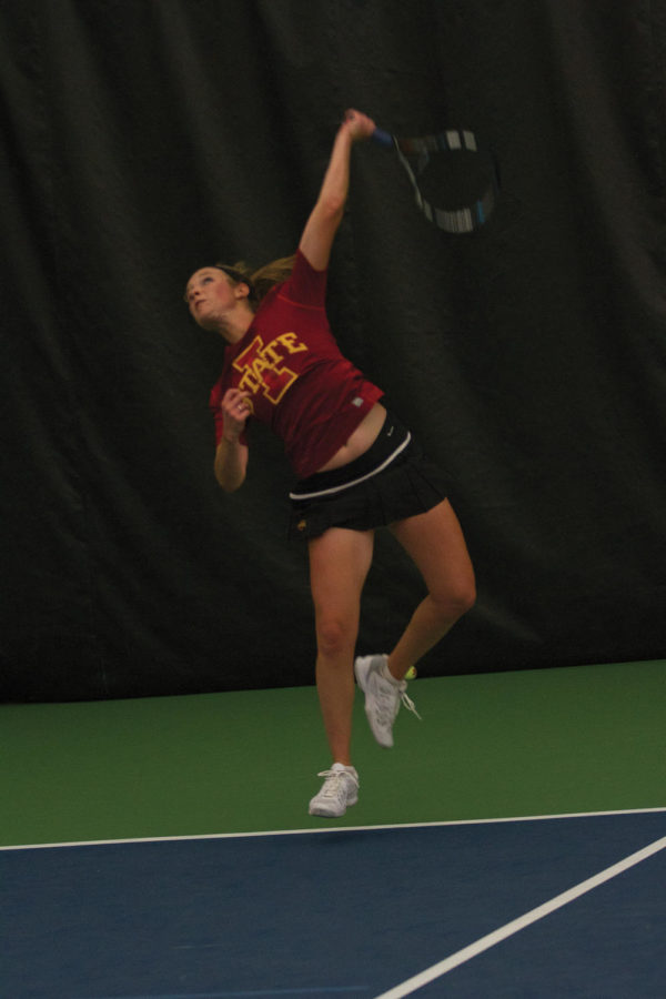 ISU junior Jenna Langhorst reaches to hit the tennis ball in her singles match. Langhorst lost her match after playing three sets against her Kansas State opponent. The team faced up against Kansas State Friday, April 13 at Ames Racquet and Fitness.
