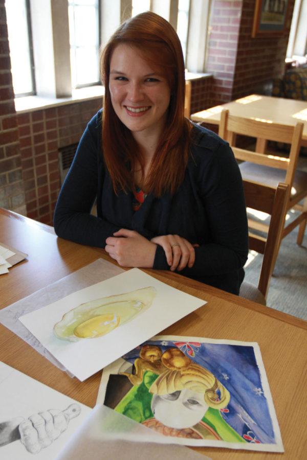 Marley Dobyns, junior on the ISU diving team, shows off her drawings on Thursday, March 29, in the Terrace Room of Friley. Dobyns enjoys drawing and dance as well as diving.

