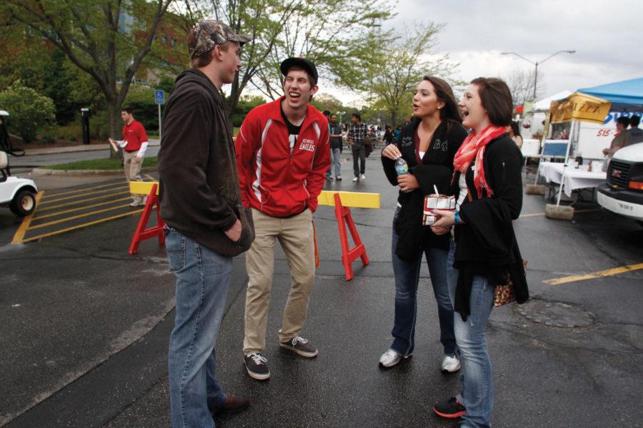 Logan Gethmann, left, of Hubbard, Iowa; Sam Patterson, sophomore in animal science; Alesha Kadolph of Hubbard; and Mariah Knight of Eldora, Iowa, laugh while grabbing a bite to eat at Taste of Veishea in the Molecular Biology parking lot on Saturday, April 21. Gethmann has been admitted to Iowa State as a freshman later this year and wanted to check out Veishea before moving in in August. 

