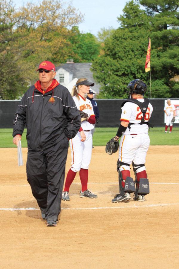 ISU assistant coach Gary Hines walks away from the mound after chatting with sophomore pitcher Taylor Smith and sophomore catcher Kayla Hardiman during the Cyclones second game against Texas A&M on Friday, April 6, at the Southwest Athletic Complex. Smith gave up six runs in five innings pitched in the 11-3 loss to the Aggies. 
