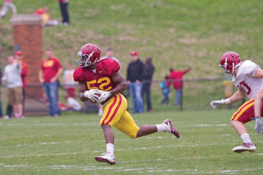 Linebacker Jeremiah George moves the ball around his opposition during the annual spring game on Saturday, April 14, at Jack Trice Stadium. The Cardinal team defeated the Gold team 13-7.
