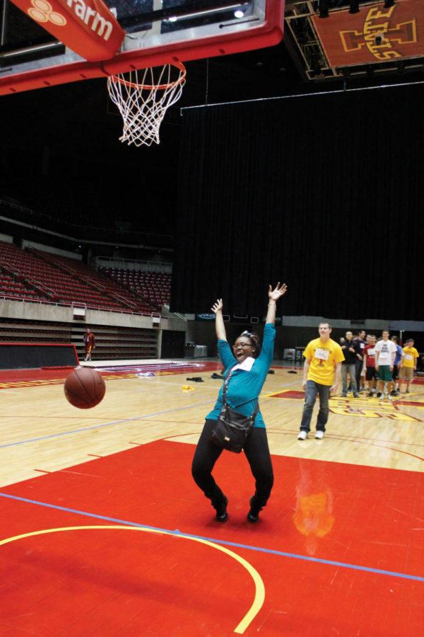 Samantha Melvin, junior in English education, celebrates after successfully making a basket during the Guinness World Record-setting game of knockout at Hilton Coliseum on Tuesday, April 17. After having last years record beat earlier this month, the second annual Veishea knockout game re-set the record with 571 participants. 
