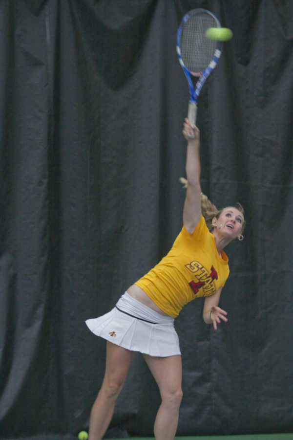 Junior Tessa Lang serves the ball during the match against Texas A&M on Friday, April 15. Lang won her match against A&Ms Christi Liles, while Iowa State lost overall with a final score of 3-4.