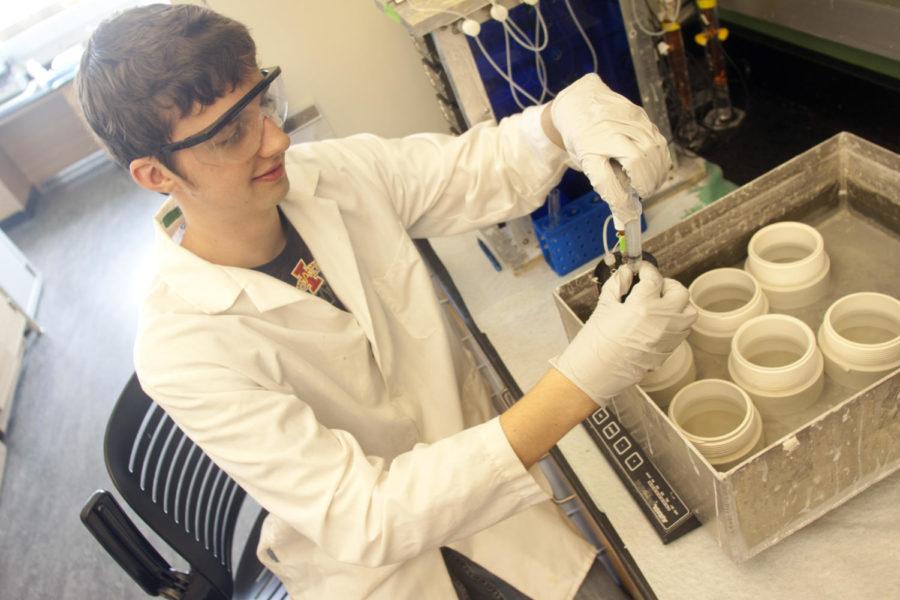 Mark Deaton, junior in chemical engineering, takes samples of
the E. coli strain from a water bath Wednesday, Sept. 21, in the
new Biorenewables Research Laboratory. The fermentation process of
the E. coli eats the sugars in the bio-oil and produces ethanol,
aiding in the labs renewable biofuel quest. 
