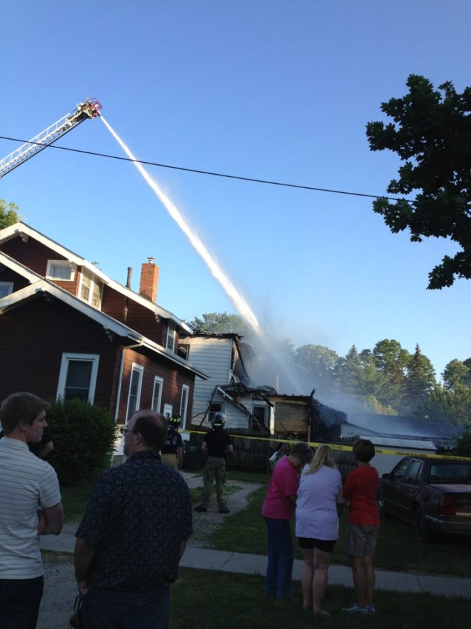 Firefighters attempt to extinguish a house fire on the corner of Ninth Street and Duff Avenue. 
